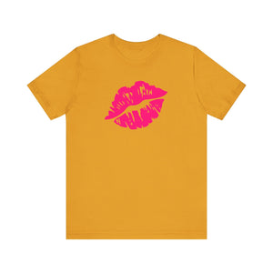 Neon pink lip print tee on orange backdrop, statement fashion piece.