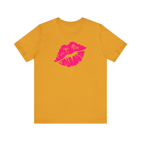 Neon pink lip print tee on orange backdrop, statement fashion piece.